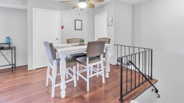 a view of a dining room with furniture and wooden floor