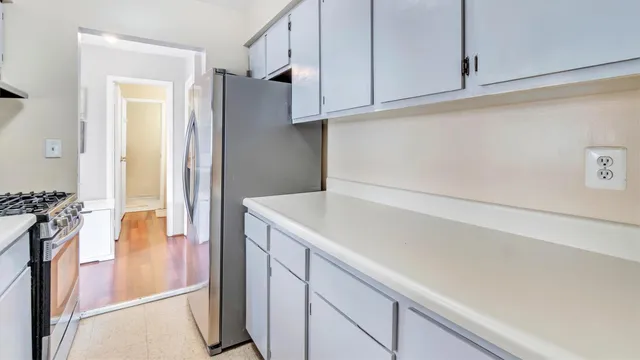 a kitchen with a refrigerator and a stove