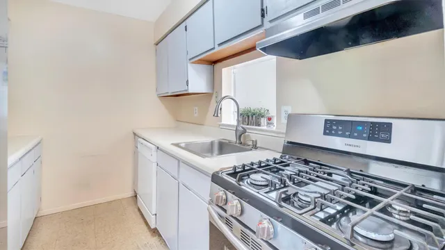 a kitchen with a stove and a white refrigerator