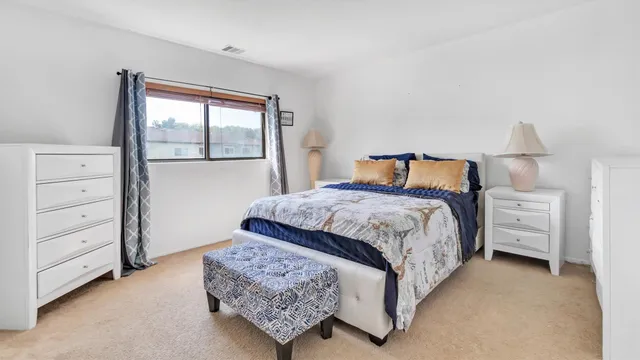 a bedroom with a bed and a window