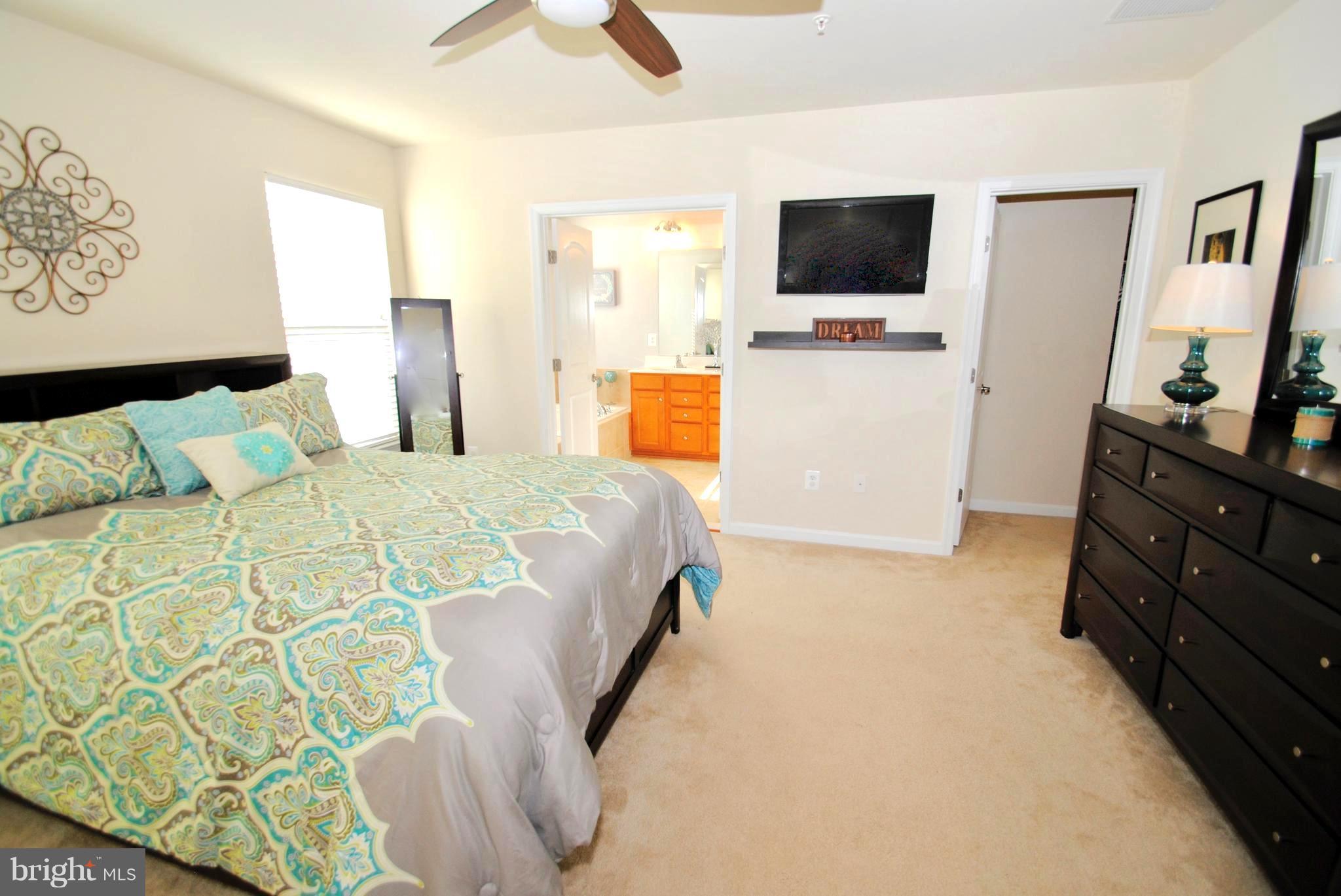 2707 Amber Crest Road Hanover, MD 21076 - Photo 13 of 30 a bedroom with a bed and flat screen tv