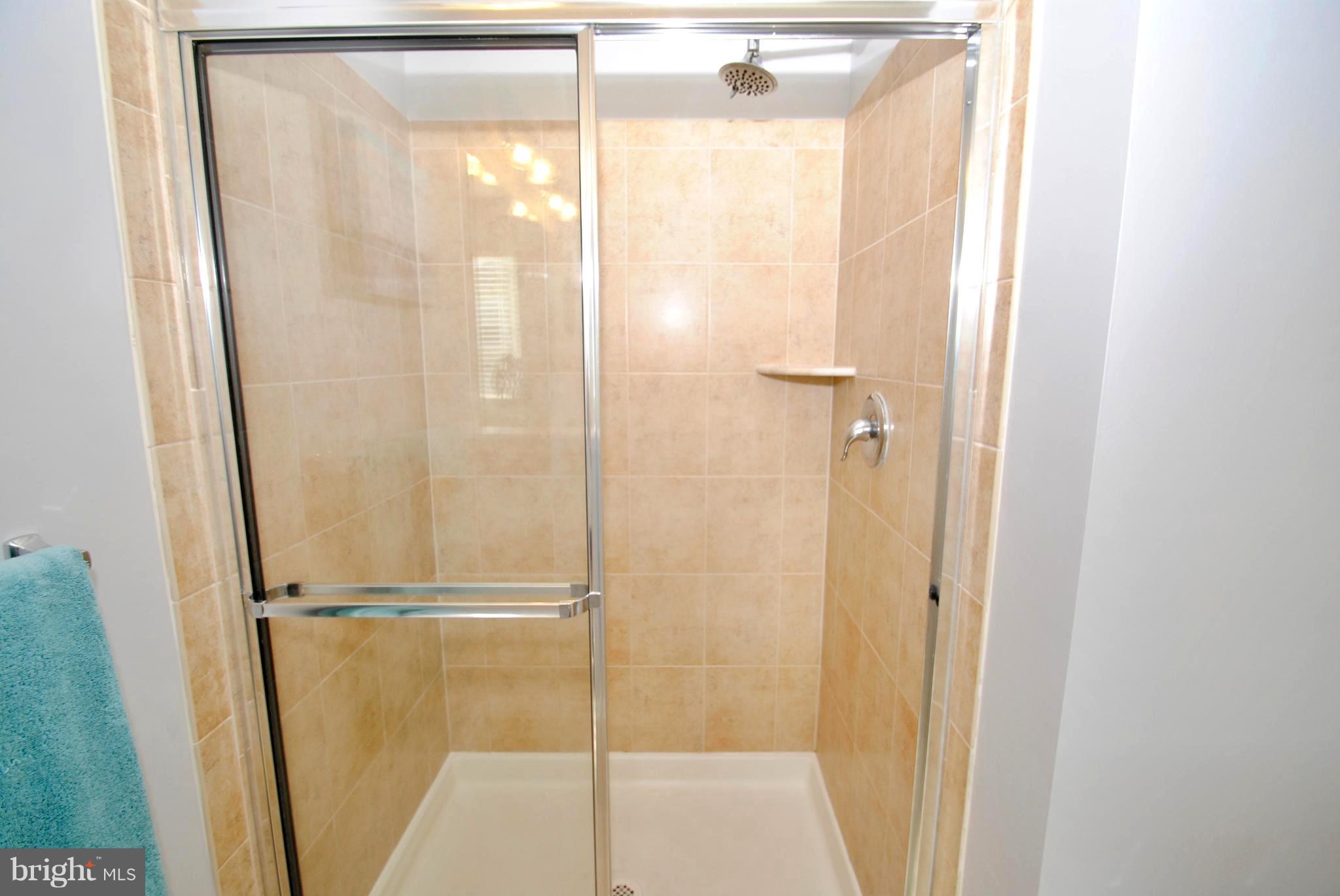 2707 Amber Crest Road Hanover, MD 21076 - Photo 16 of 30 a bathroom with a glass shower door