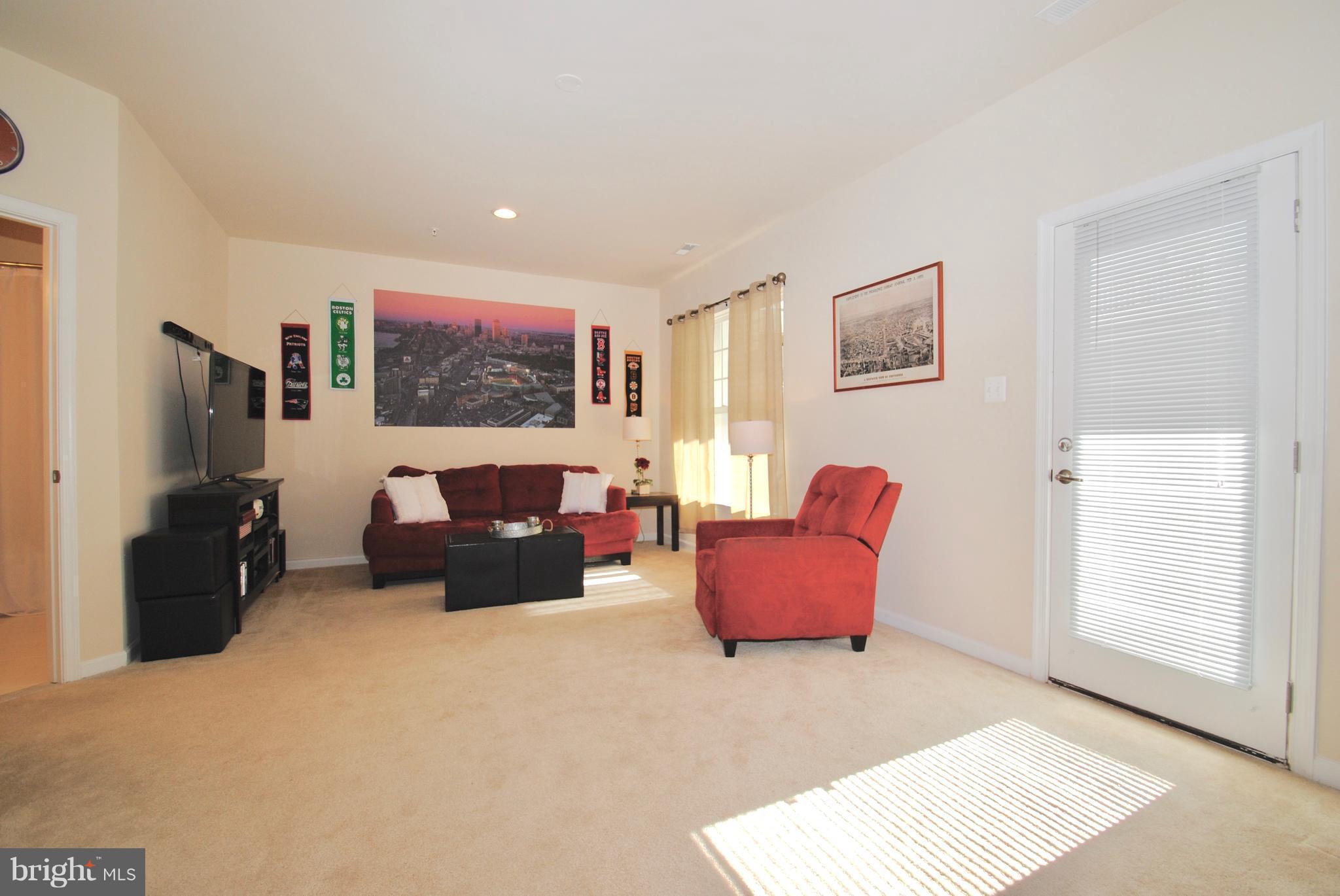 2707 Amber Crest Road Hanover, MD 21076 - Photo 23 of 30 a living room with furniture and a flat screen tv
