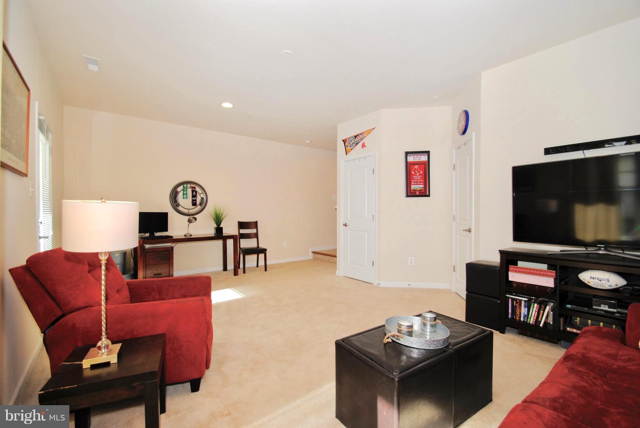 2707 Amber Crest Road Hanover, MD 21076 - Photo 24 of 30 a living room with furniture and a flat screen tv