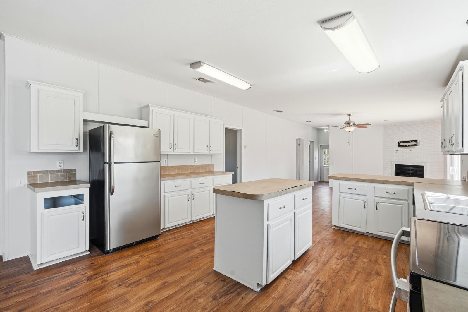 299 Cayenne Street Interlachen, FL 32148 - Photo 14 of 73 Kitchen featuring electric stove, freestanding refrigerator, dark wood finished floors, and white cabinets