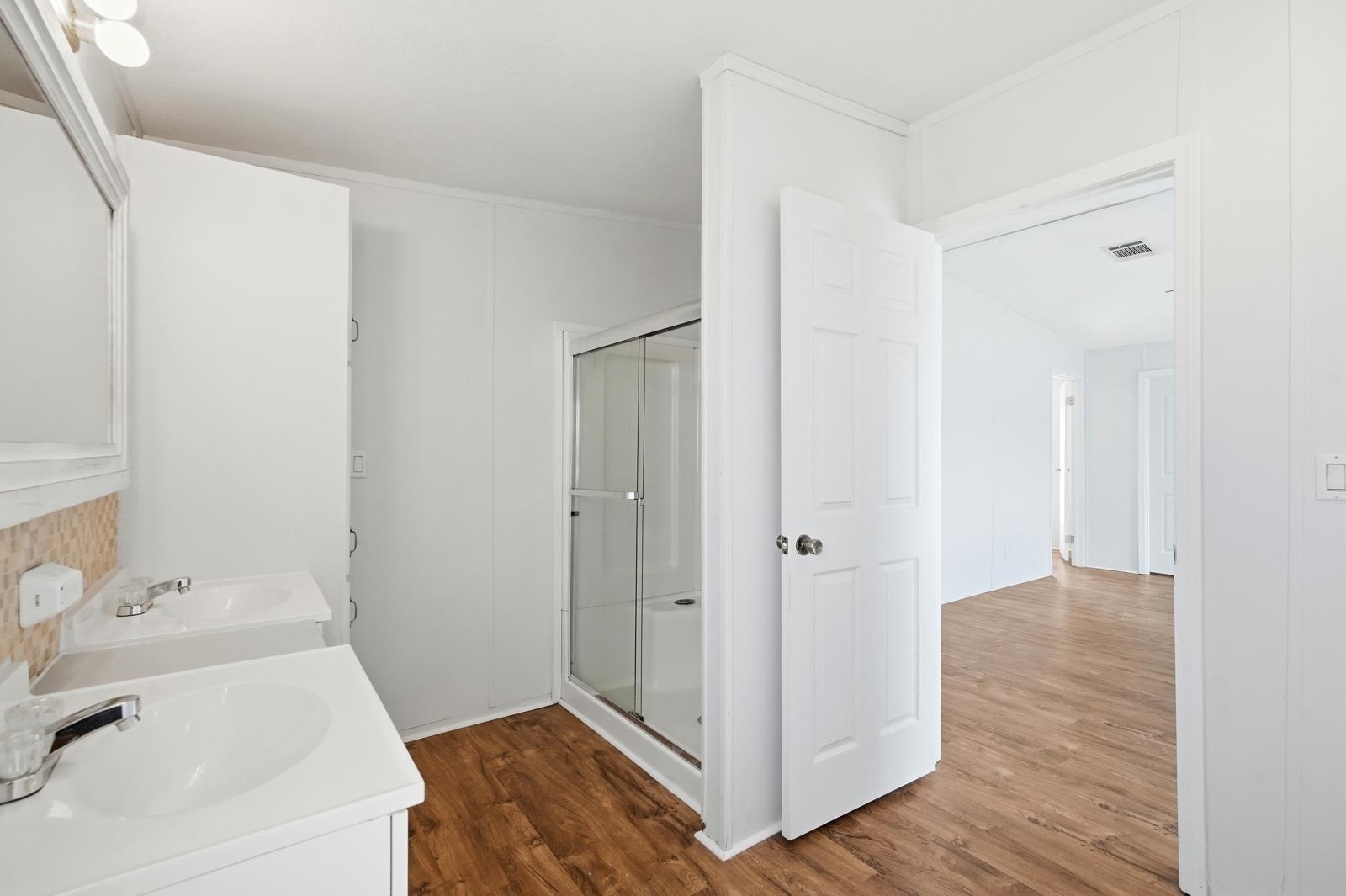 299 Cayenne Street Interlachen, FL 32148 - Photo 26 of 73 Bathroom with vanity, a stall shower, and dark wood-style floors