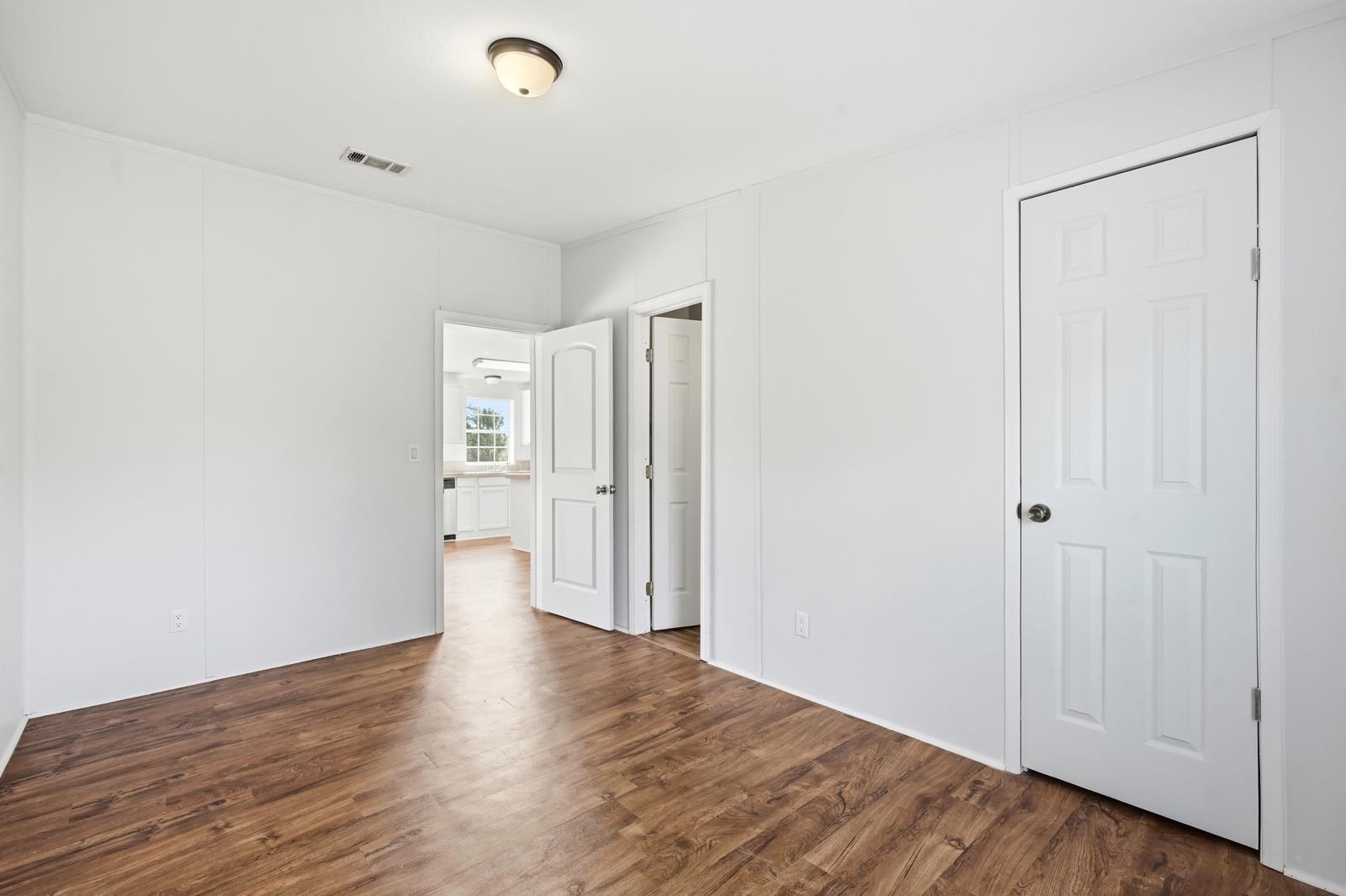 299 Cayenne Street Interlachen, FL 32148 - Photo 31 of 73 Unfurnished bedroom featuring dark wood-style flooring