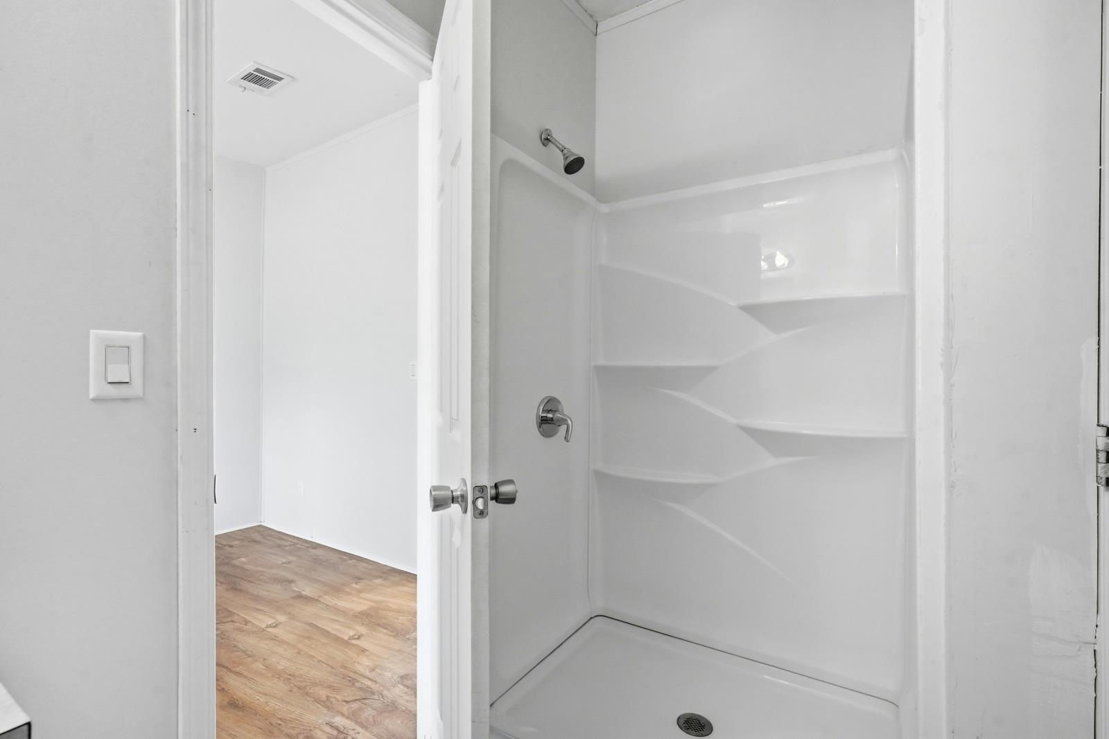 299 Cayenne Street Interlachen, FL 32148 - Photo 33 of 73 Bathroom featuring light wood-type flooring and a stall shower
