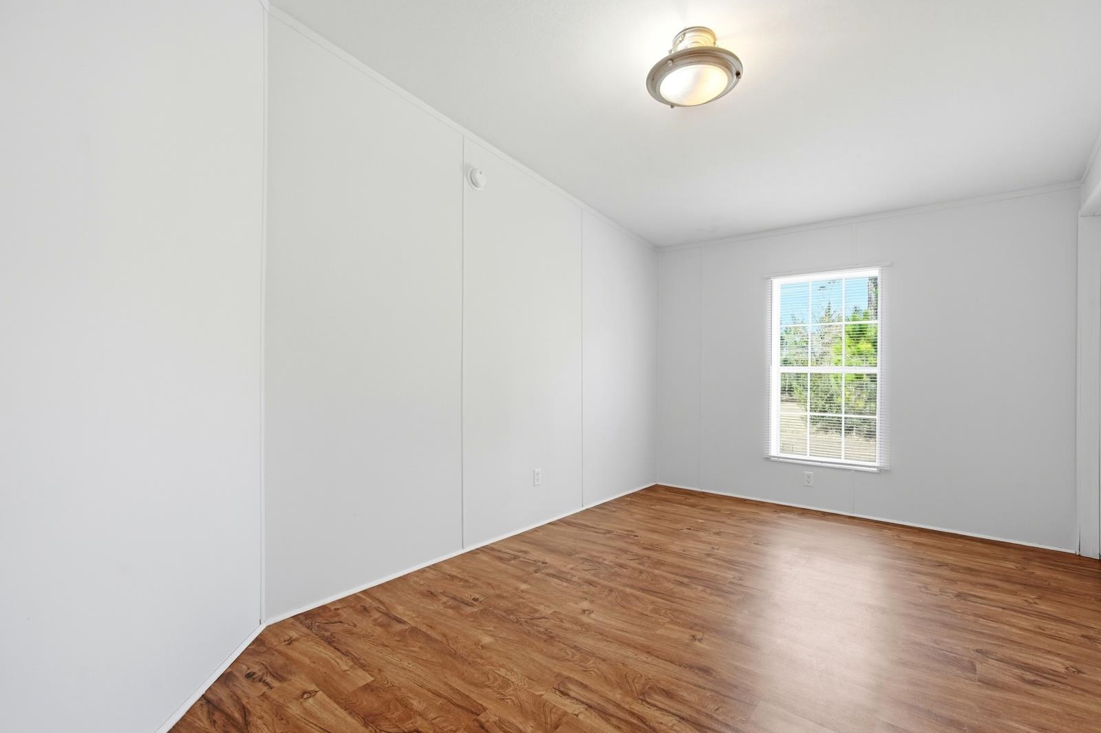 299 Cayenne Street Interlachen, FL 32148 - Photo 34 of 73 Unfurnished room featuring wood finished floors and ornamental molding