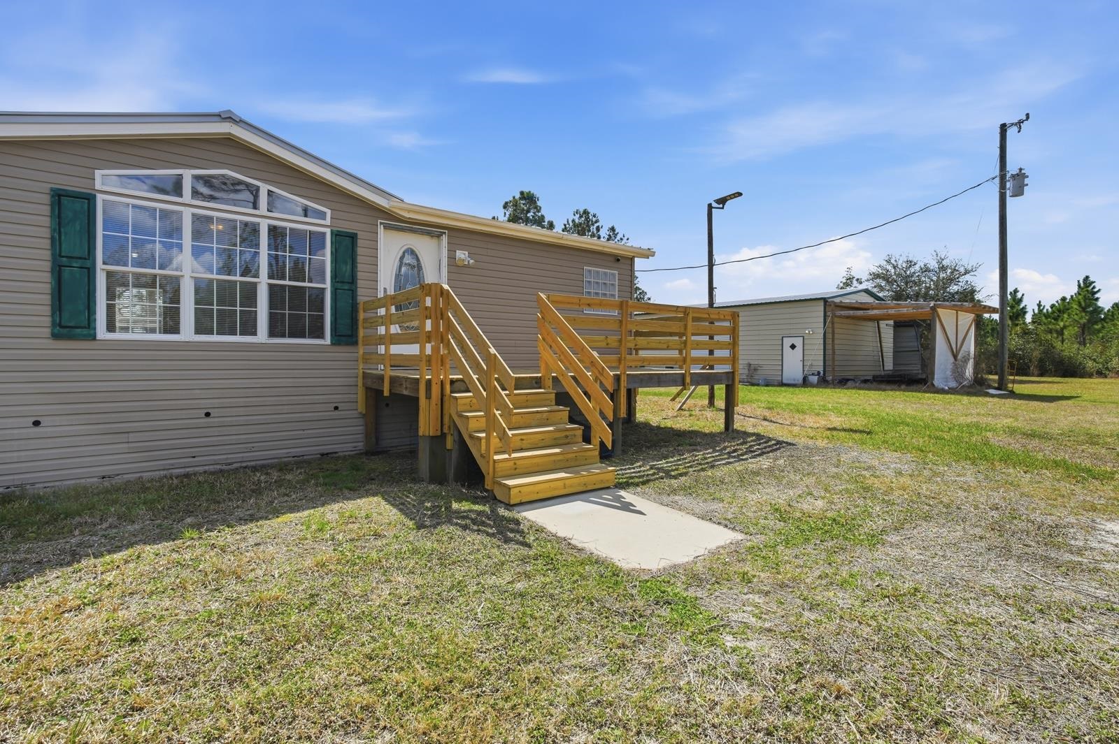 299 Cayenne Street Interlachen, FL 32148 - Photo 4 of 73 Rear view of house featuring a lawn and stairs