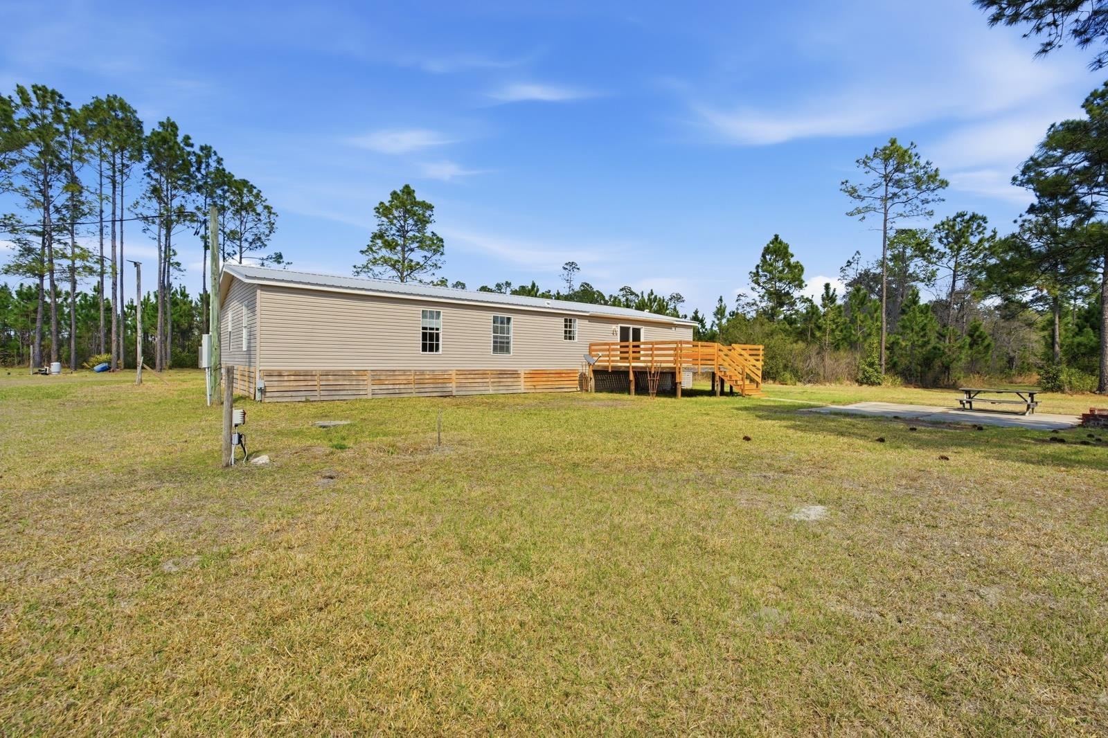 299 Cayenne Street Interlachen, FL 32148 - Photo 46 of 73 Back of house with a yard and a wooden deck