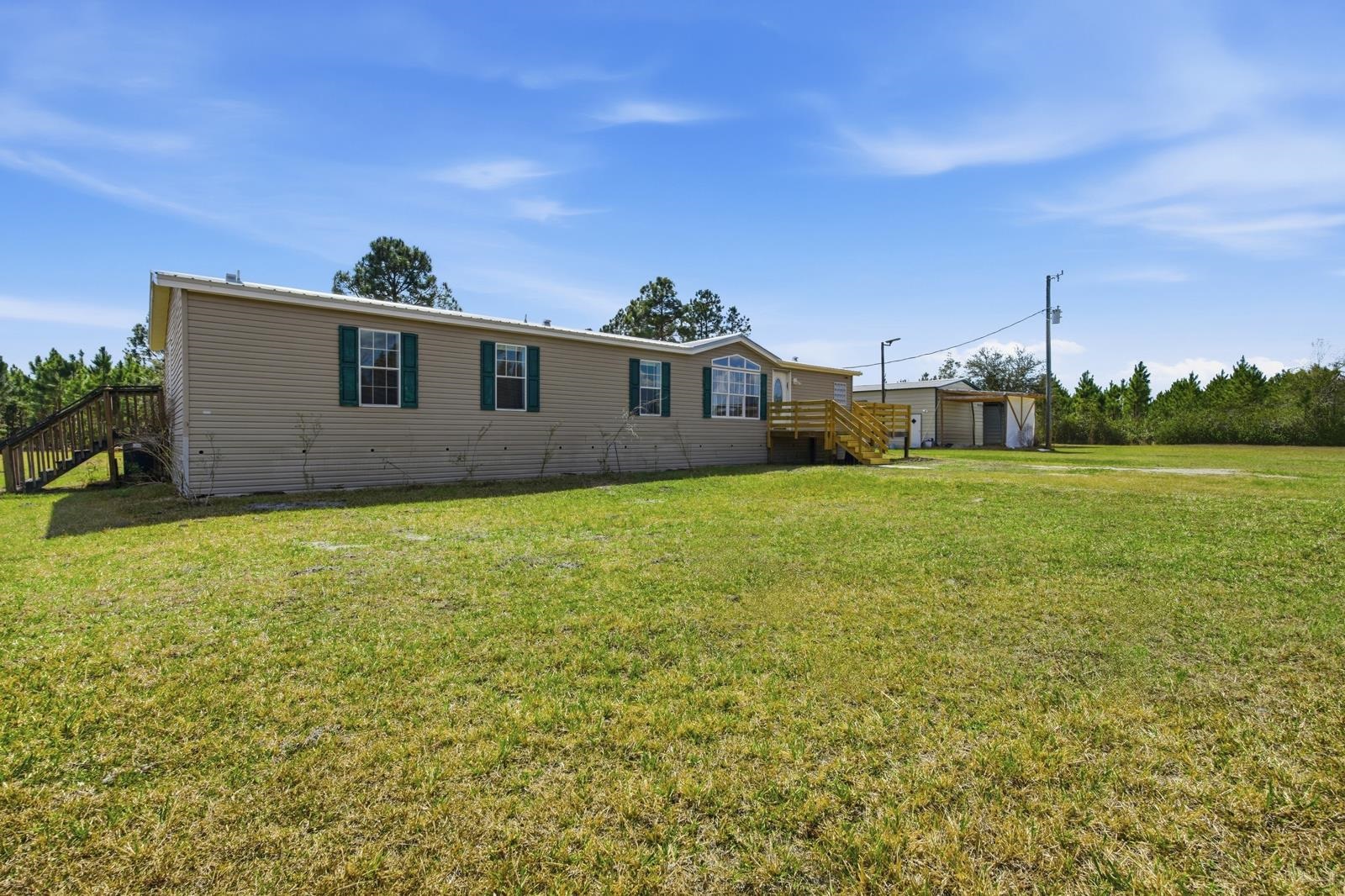 299 Cayenne Street Interlachen, FL 32148 - Photo 6 of 73 View of front of home featuring a front lawn and a wooden deck