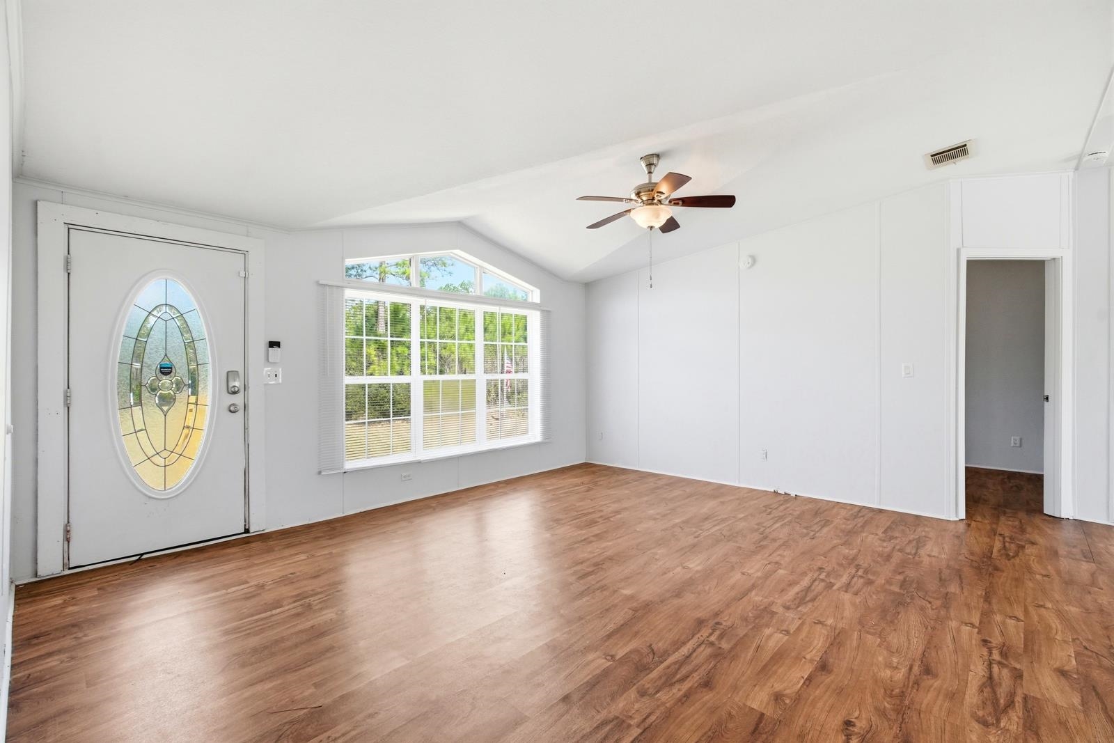 299 Cayenne Street Interlachen, FL 32148 - Photo 10 of 73 Entrance foyer with dark wood-type flooring, ceiling fan, and vaulted ceiling