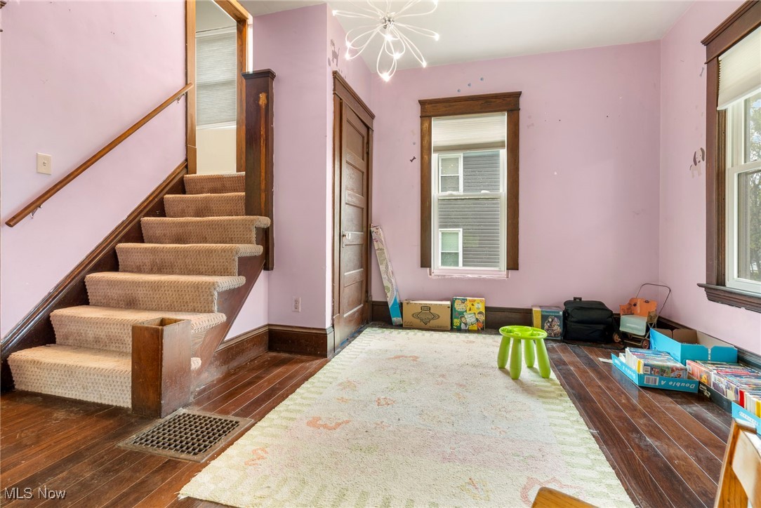 6453 Waterloo Road Atwater, OH 44201 - Photo 5 of 24 Stairs featuring wood-type flooring and a chandelier