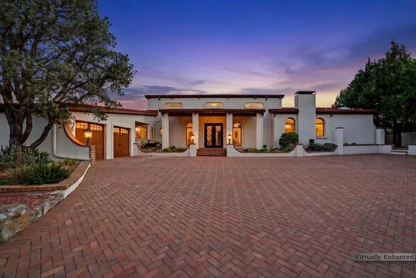 a front view of a house with a yard and outdoor seating