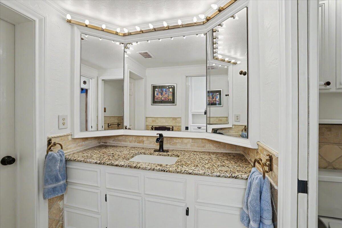 5 West Lakeshore Drive Ransom Canyon, TX 79366 - Photo 19 of 61 a bathroom with a granite countertop sink mirror and