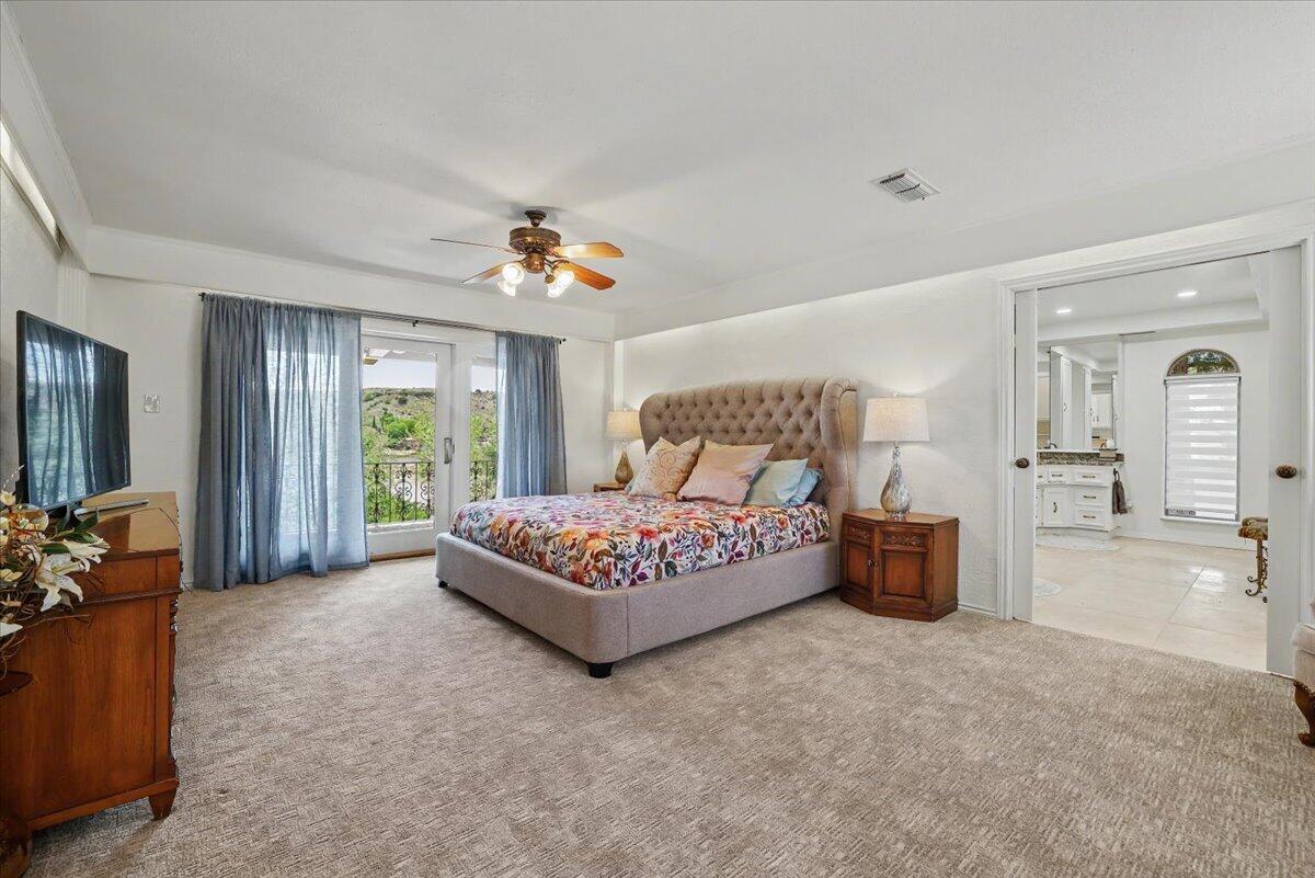 5 West Lakeshore Drive Ransom Canyon, TX 79366 - Photo 20 of 61 a spacious bedroom with a bed and a large window
