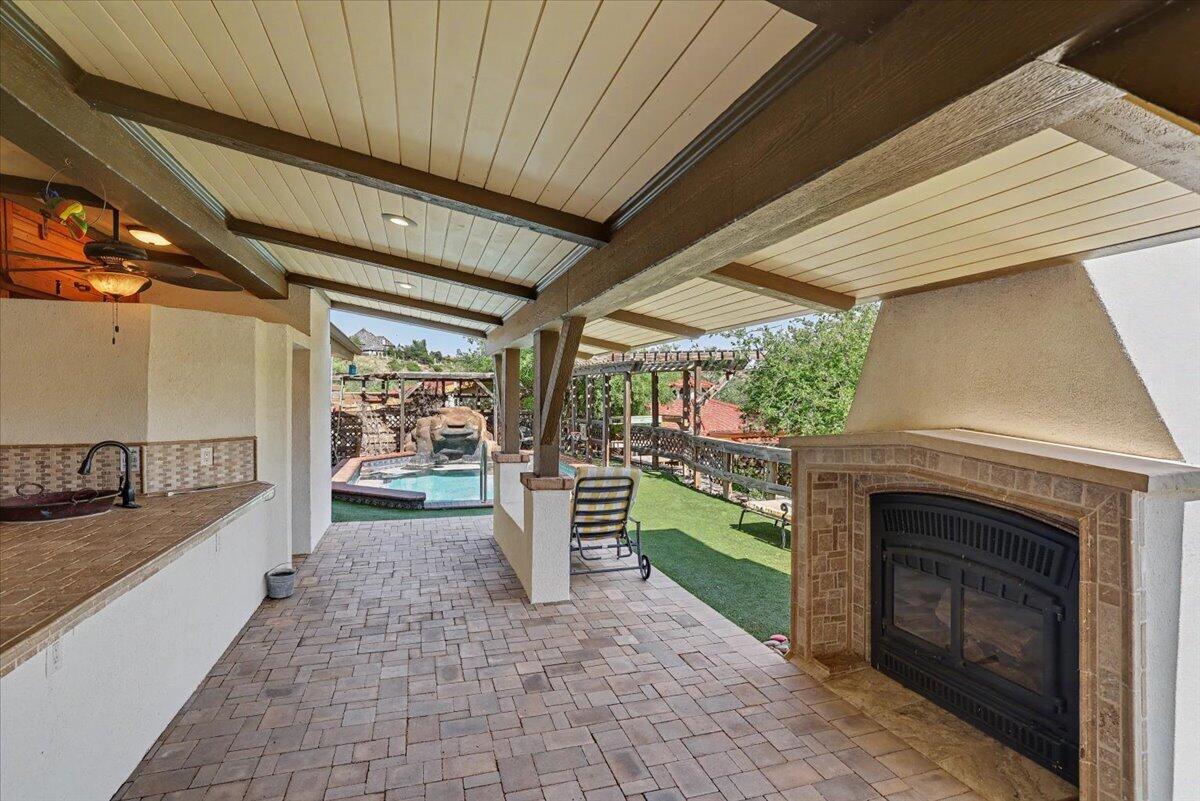 5 West Lakeshore Drive Ransom Canyon, TX 79366 - Photo 37 of 61 a porch with a table and a fireplace