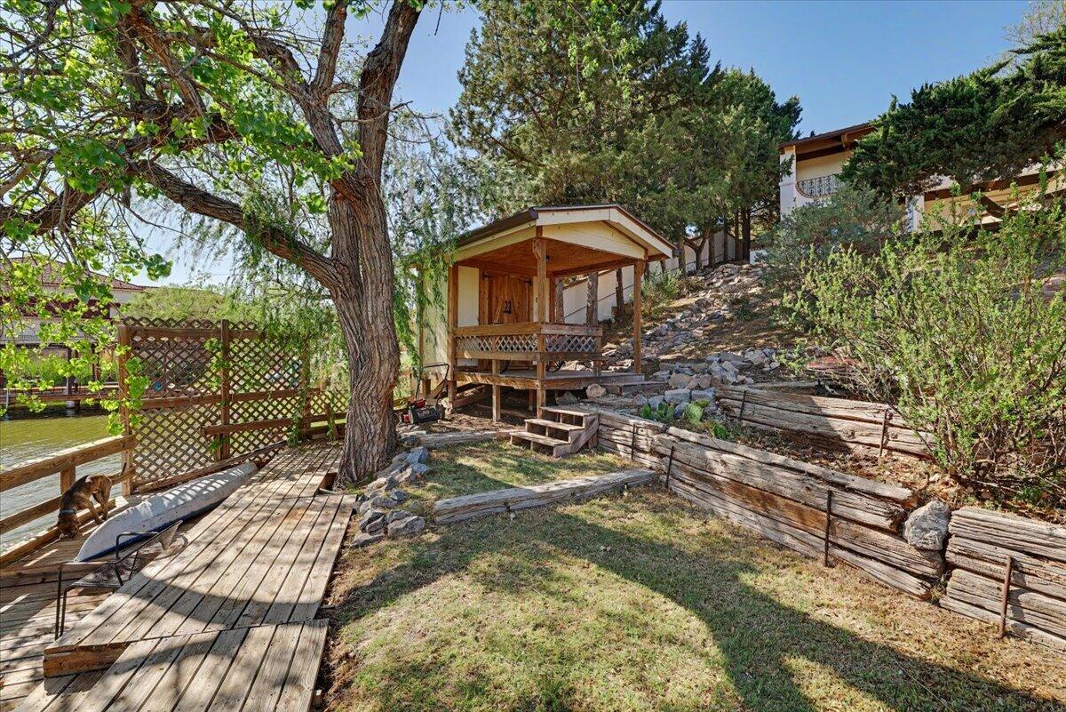 5 West Lakeshore Drive Ransom Canyon, TX 79366 - Photo 51 of 61 a view of a chairs and table in the wooden deck