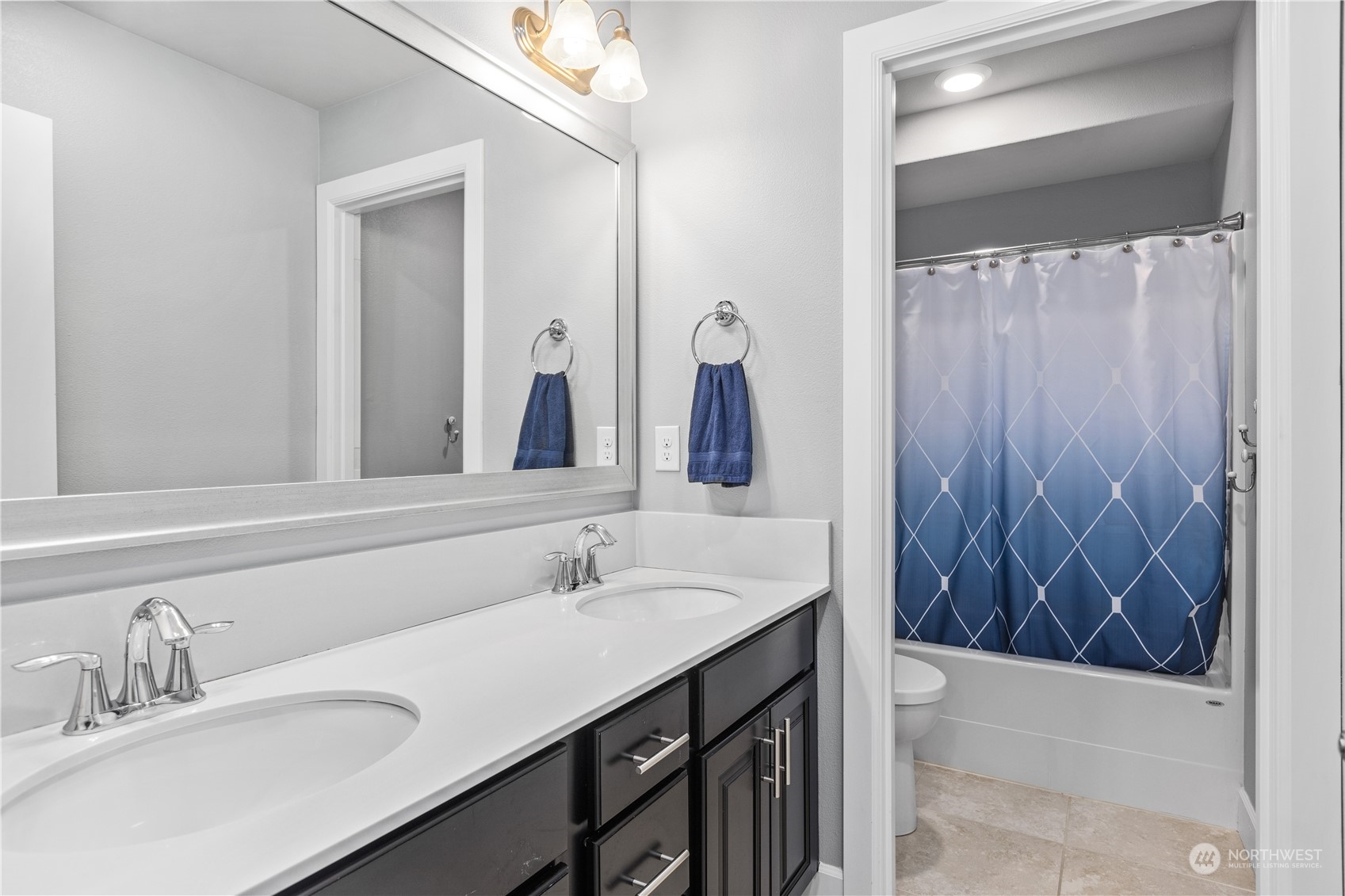 17517 40th Drive Southeast Bothell, WA 98012 - Photo 31 of 40 a bathroom with a double vanity sink and a mirror