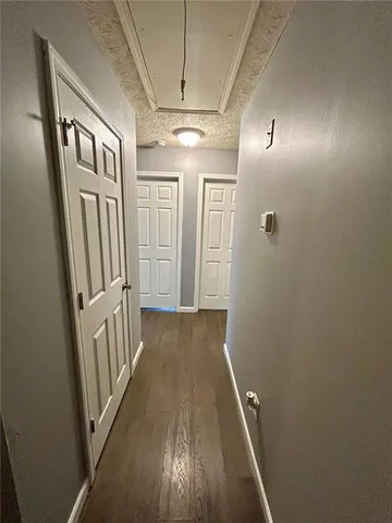 a view of hallway with wooden floor