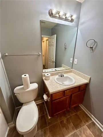a bathroom with a sink mirror and toilet