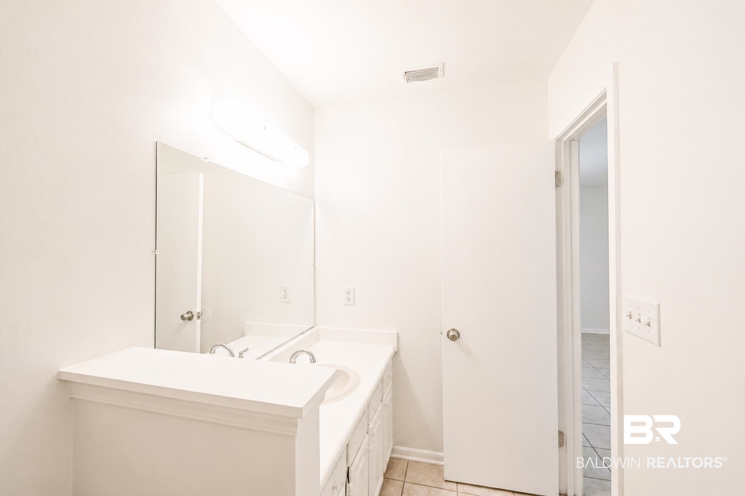 614 East Gate Circle Foley, AL 36535 - Photo 26 of 31 Bathroom featuring a dual-sink vanity with white cabinetry, a large wall-mounted mirror, overhead lighting, and tile flooring