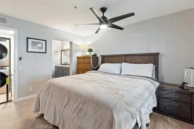 a bedroom with a bed and painting on the wall