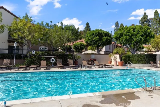 a view of a house with backyard sitting area and garden