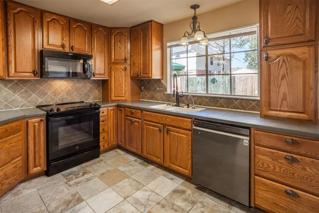 a kitchen with a sink stove and microwave