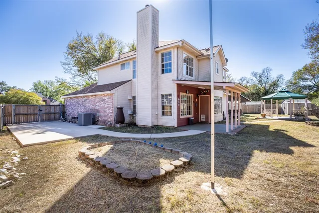 a front view of a house with a yard and balcony