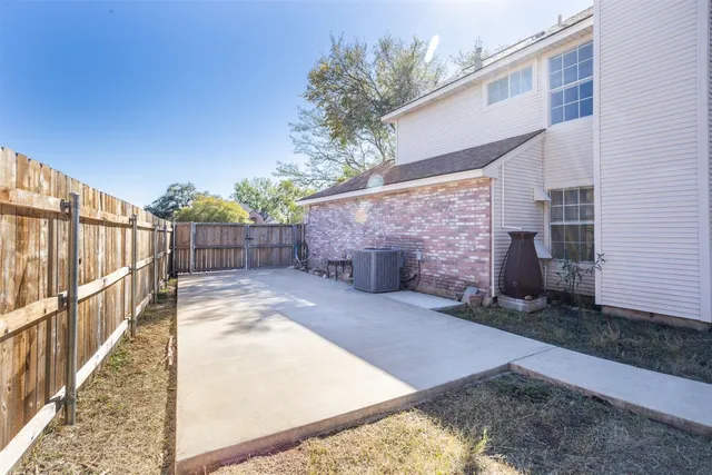 a view of a backyard with wooden fence