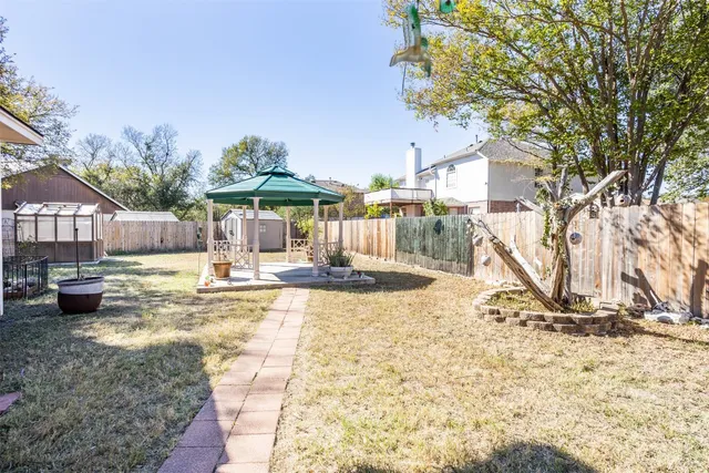 a view of a house with a yard and sitting area