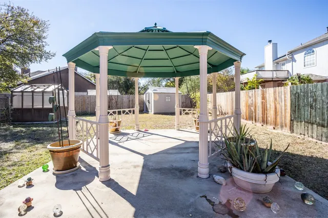 a view of a chair and table in backyard
