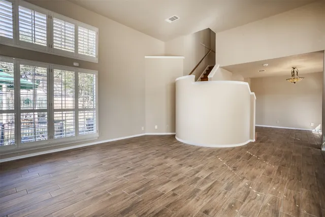 a view of a room with wooden floor and white walls