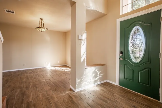 a view of a hallway with wooden floor