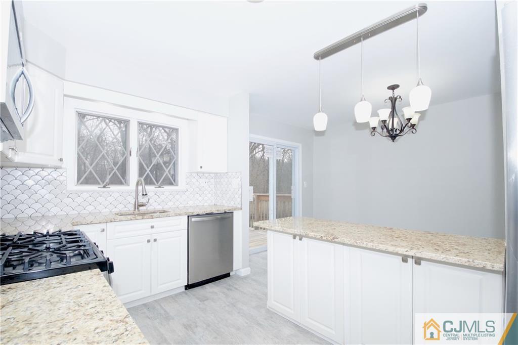 9 Brookside Road Edison, NJ 08817 - Photo 12 of 24 a kitchen with a sink a stove and cabinets