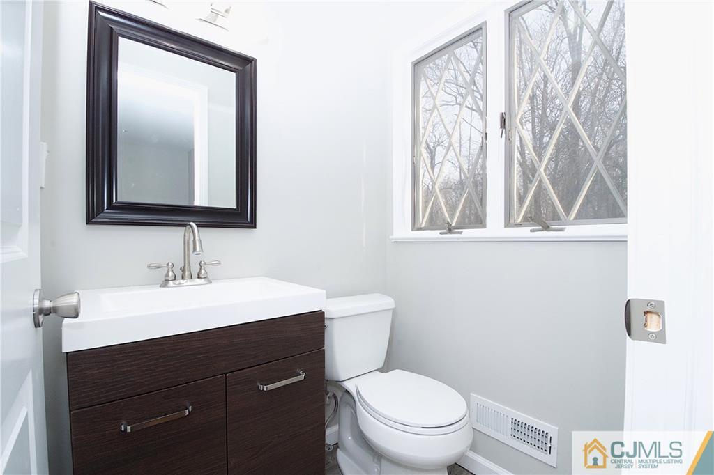 9 Brookside Road Edison, NJ 08817 - Photo 15 of 24 a bathroom with a toilet a sink and mirror