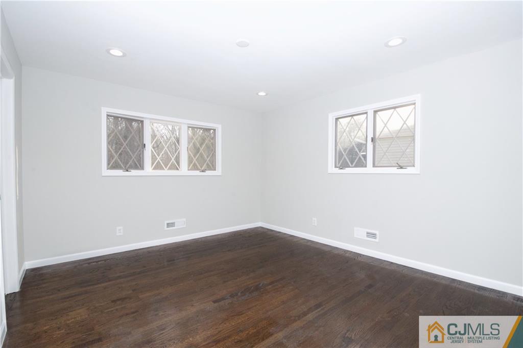 9 Brookside Road Edison, NJ 08817 - Photo 18 of 24 an empty room with wooden floor and windows
