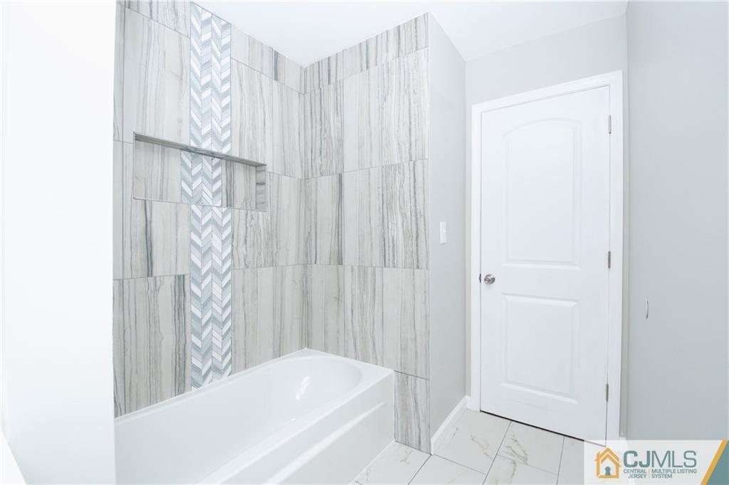 9 Brookside Road Edison, NJ 08817 - Photo 22 of 24 a bathroom with a bathtub and shower