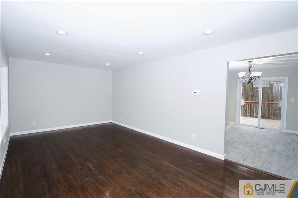 9 Brookside Road Edison, NJ 08817 - Photo 5 of 24 an empty room with wooden floor and windows