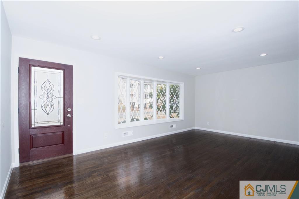 9 Brookside Road Edison, NJ 08817 - Photo 6 of 24 a view of an empty room with wooden floor and a window