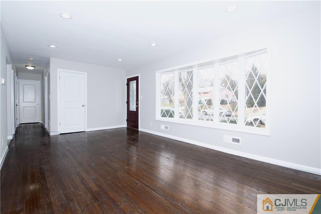 9 Brookside Road Edison, NJ 08817 - Photo 7 of 24 a view of an empty room with wooden floor and a window