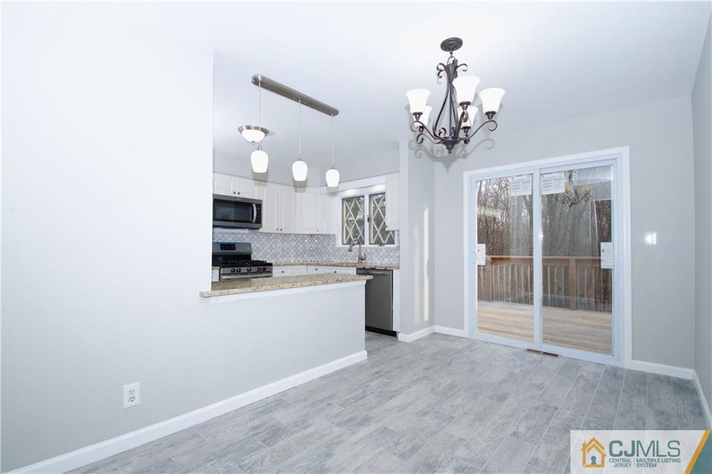 9 Brookside Road Edison, NJ 08817 - Photo 8 of 24 a view of a kitchen with granite countertop a sink and dishwasher a kitchen view