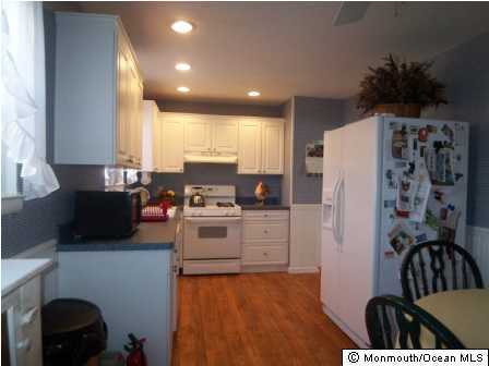 49 Darien Road Howell, NJ 07731 - Photo 3 of 3 a kitchen with refrigerator and stove