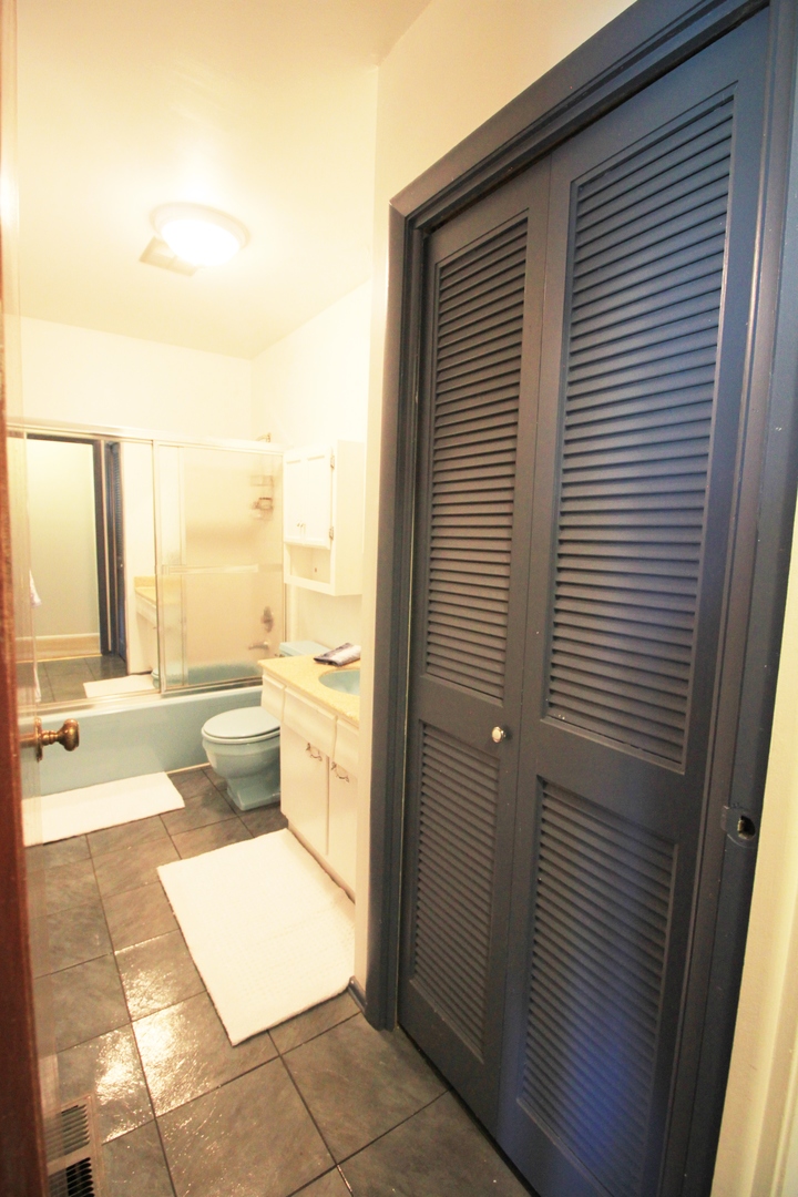 1370 Hassell Road Hoffman Estates, IL 60169 - Photo 11 of 17 a view of a bathroom with a tub and shower