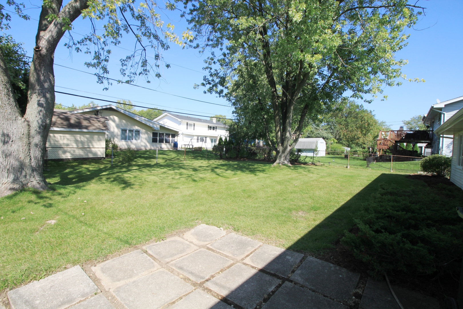 1370 Hassell Road Hoffman Estates, IL 60169 - Photo 15 of 17 a view of a house with garden and a bench