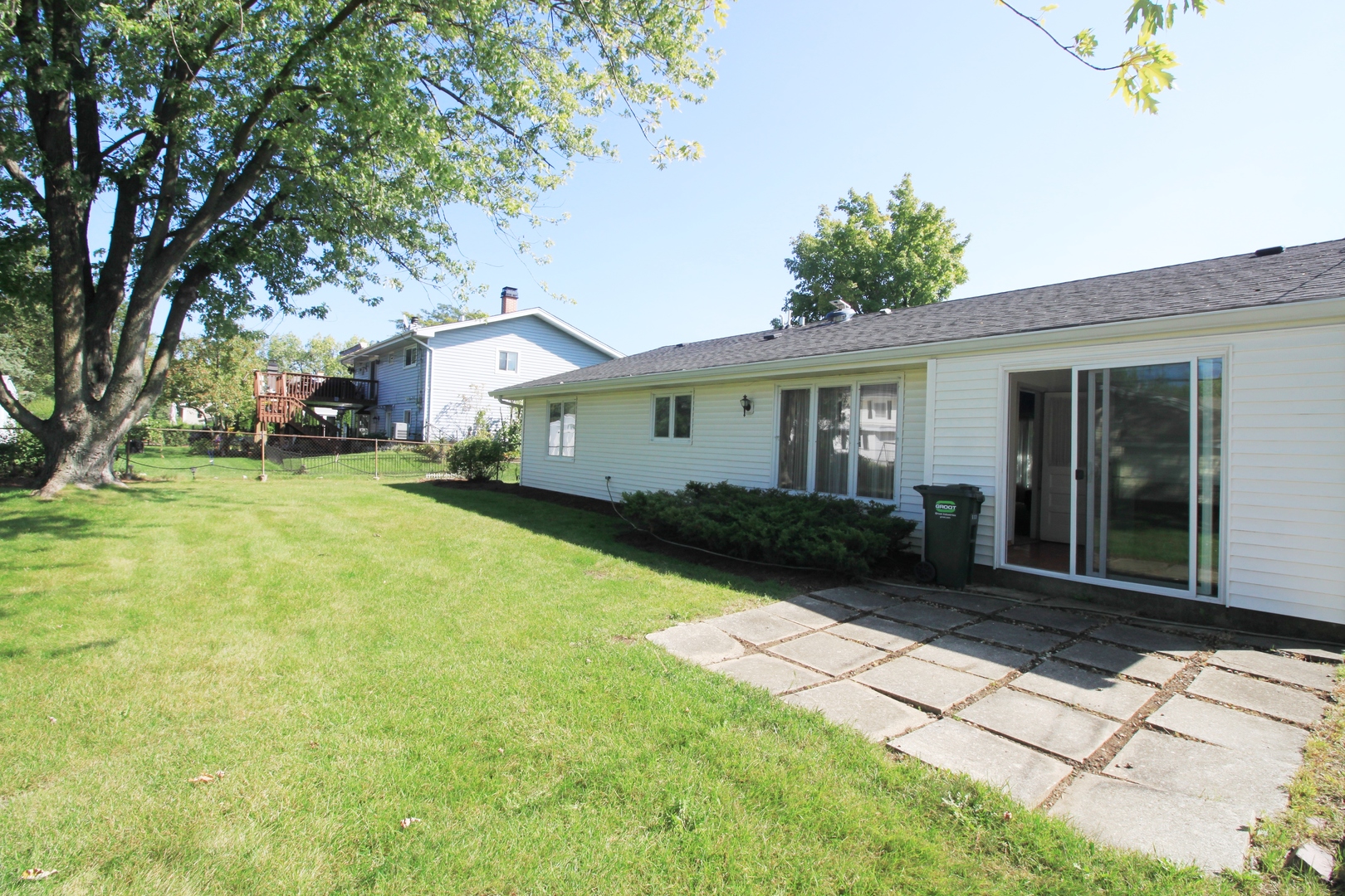 1370 Hassell Road Hoffman Estates, IL 60169 - Photo 16 of 17 a front view of a house with a yard and potted plants