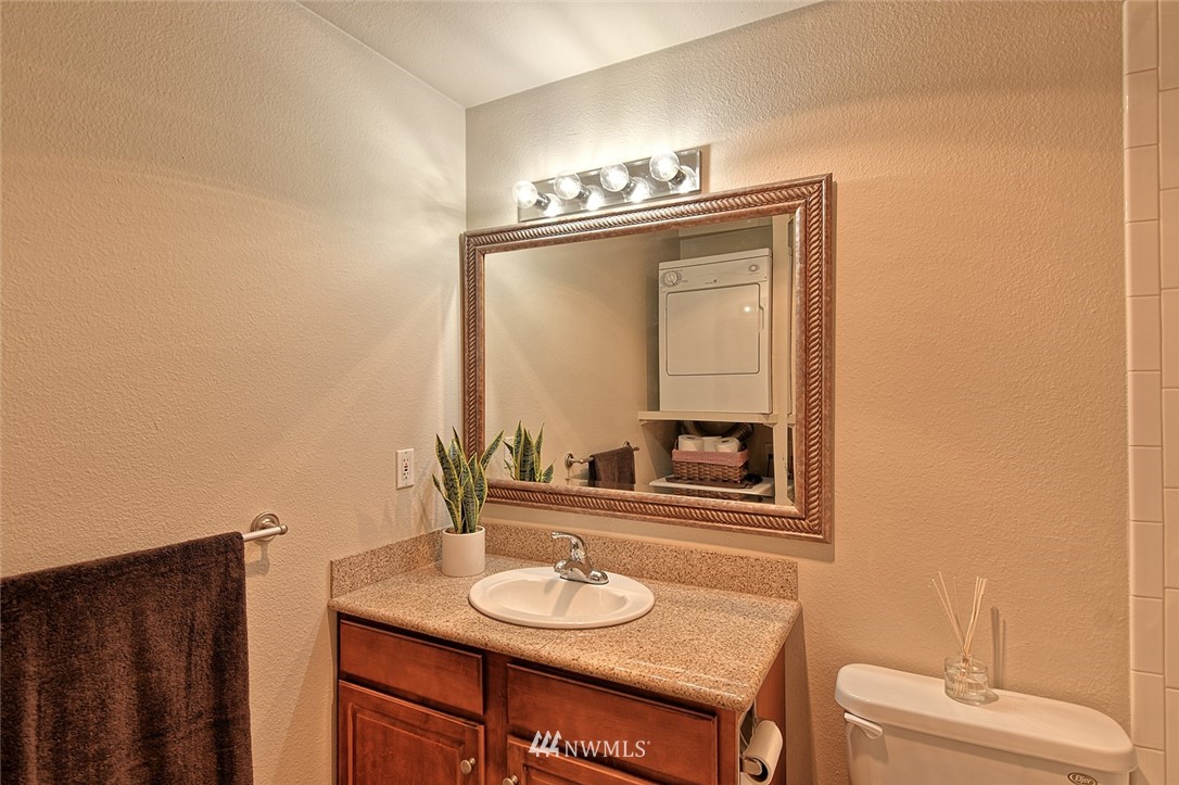 20330 Bothell Everett Highway, Unit C204 Bothell, WA 98012 - Photo 12 of 24 a bathroom with a sink and a mirror
