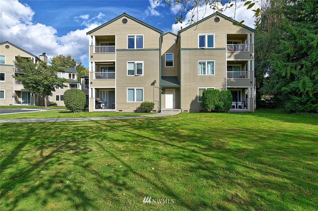 20330 Bothell Everett Highway, Unit C204 Bothell, WA 98012 - Photo 16 of 24 a front view of a house with a yard